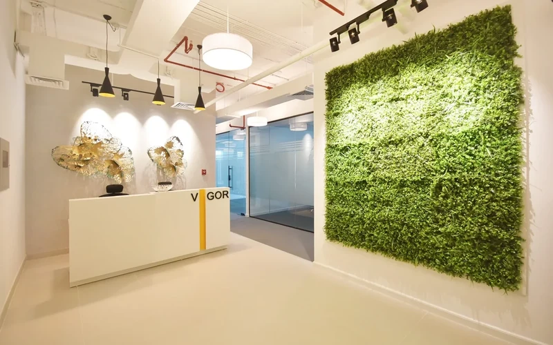 The Dzire Business Center reception in Business Bay, with the Vigor sign and living green wall